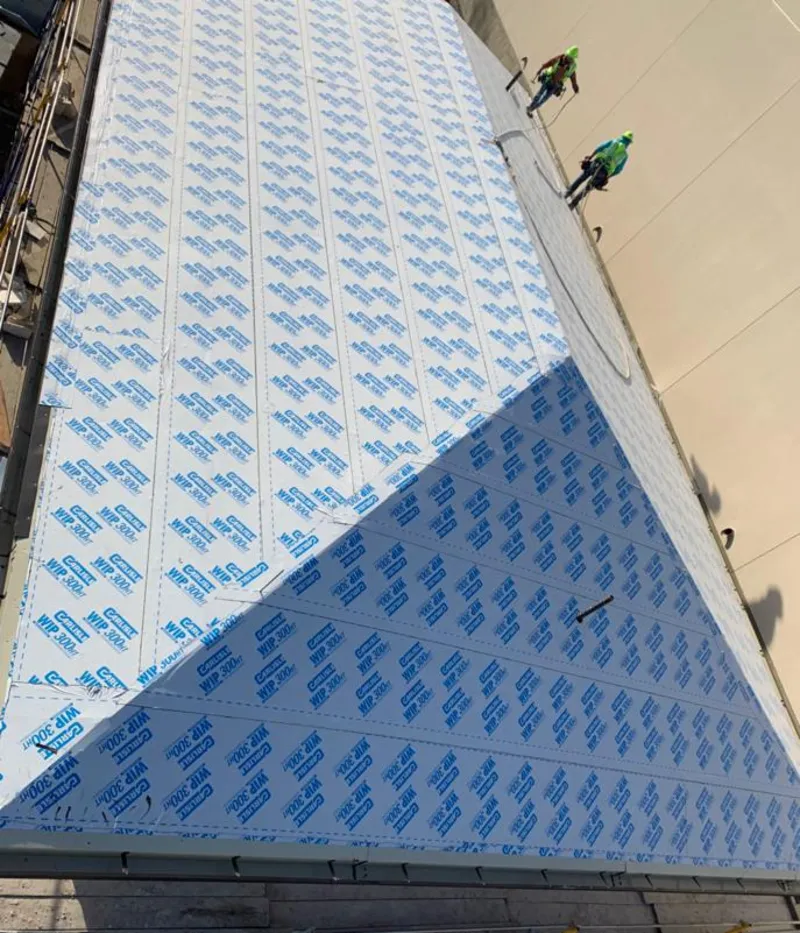 Professional roofers installing underlayment on a metal roof in Sharon Hill